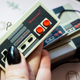 A photo of a miniature NES keychain